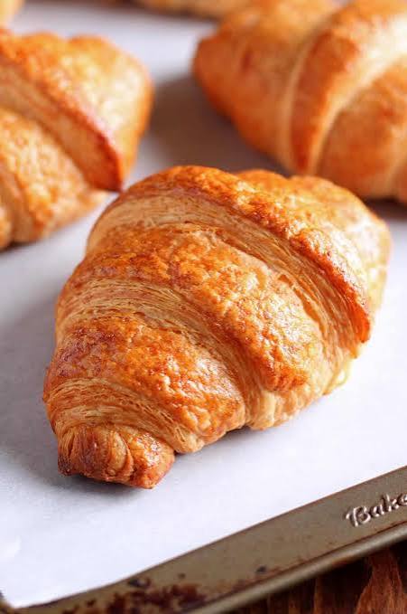 Golden butter croissants on a baking tray